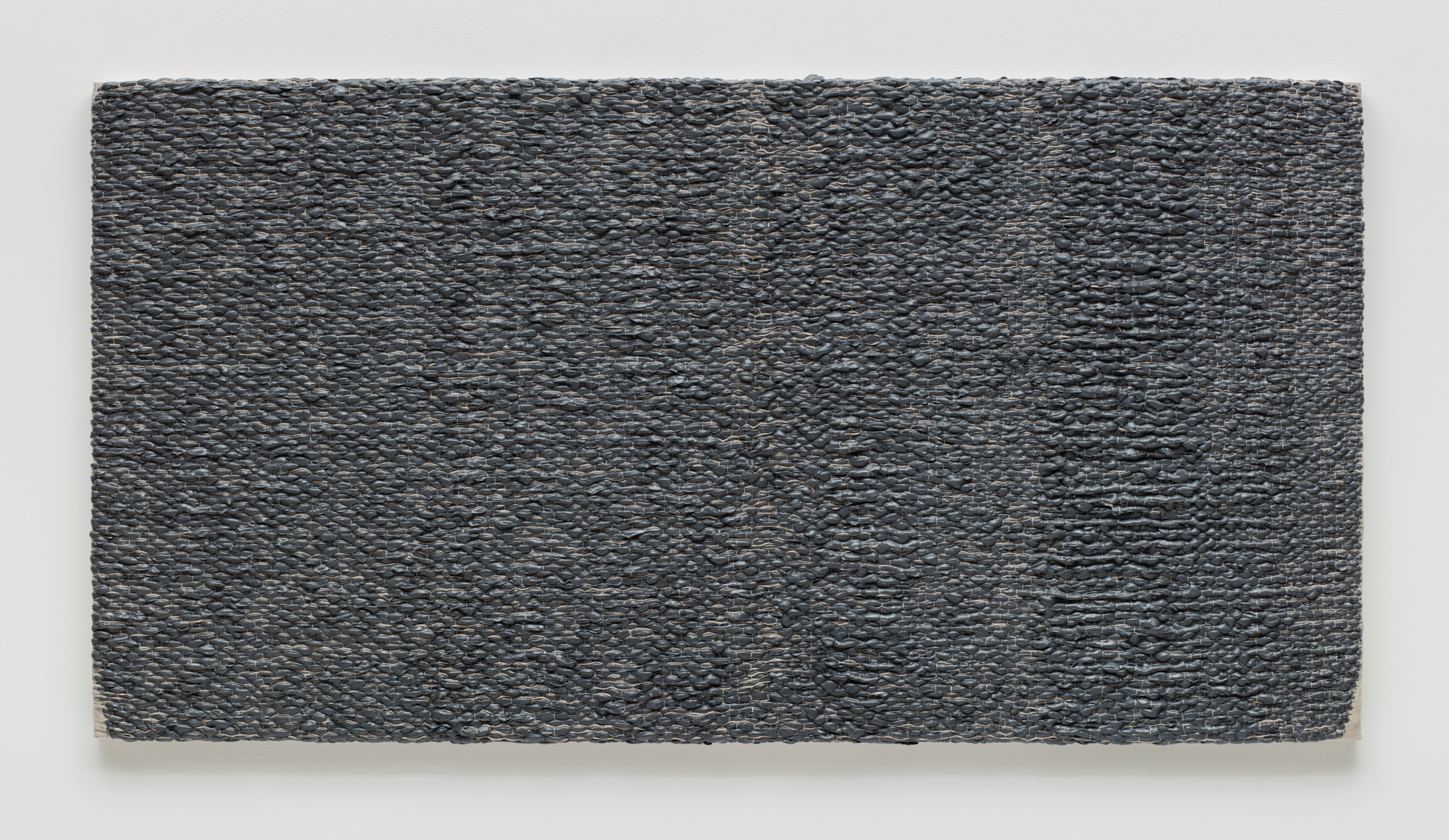 Analia Saban, Woven Solid as Warp, Horizontal (Gray) #1, 2017.  Acrylic paint woven through linen canvas on panel.  202.6 x 106 x 6.4 cm. Photo by Brian Forrest.